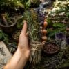 A bundle of dried herbs including lavender, rosemary, and yellow flowers, tied together with brown twine. The arrangement features a mix of green, purple, and yellow stems, showcasing a variety of textures and natural botanical elements. — Khodamdjin