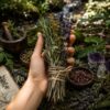 A bundle of dried herbs including purple lavender, yellow yarrow, and green rosemary stems tied together with natural twine. The arrangement features a variety of textures and earthy tones, showcasing a collection of botanical elements. — Khodamdjin